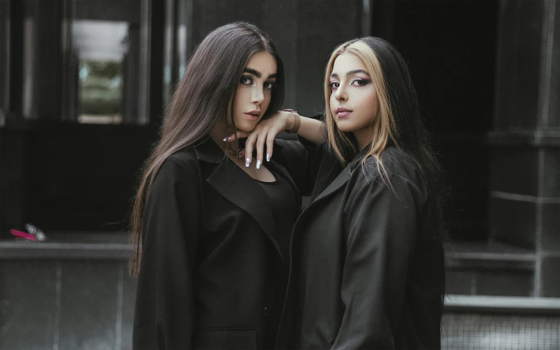 two beautiful young women standing together in the city