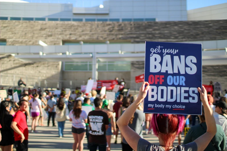 a group of people with signs protesting an anti - gay act