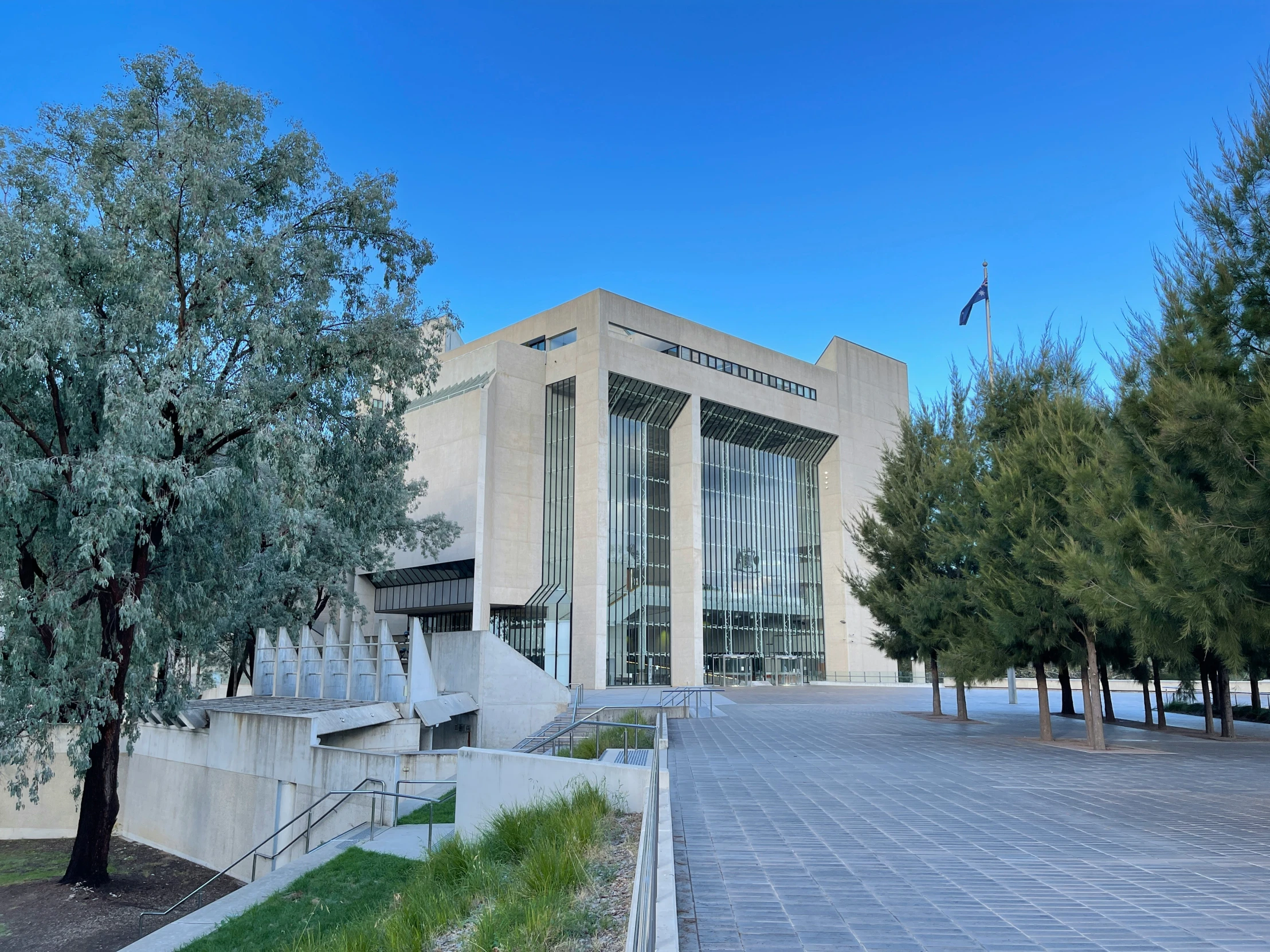 a large beige building that is in the midst of trees