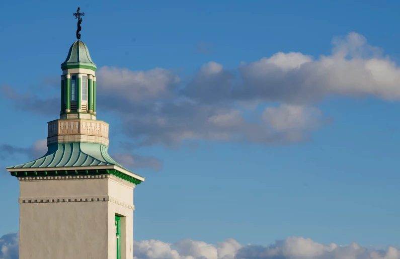 the top of the building has a steeple with a clock