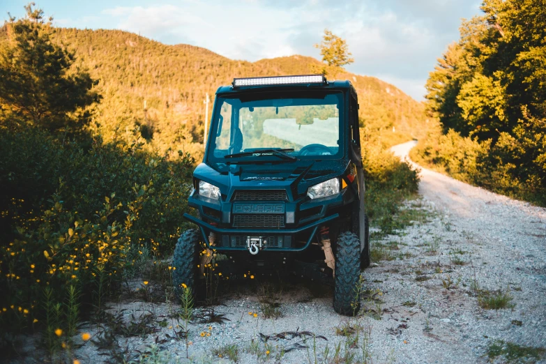 a vehicle parked on the side of a mountain road