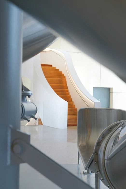 an empty hallway with a metal railing next to a staircase