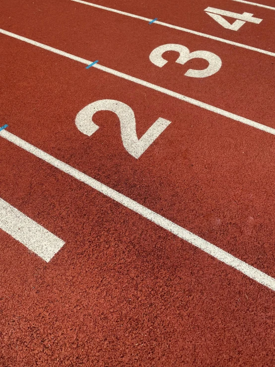 a red race track with white painted numbers