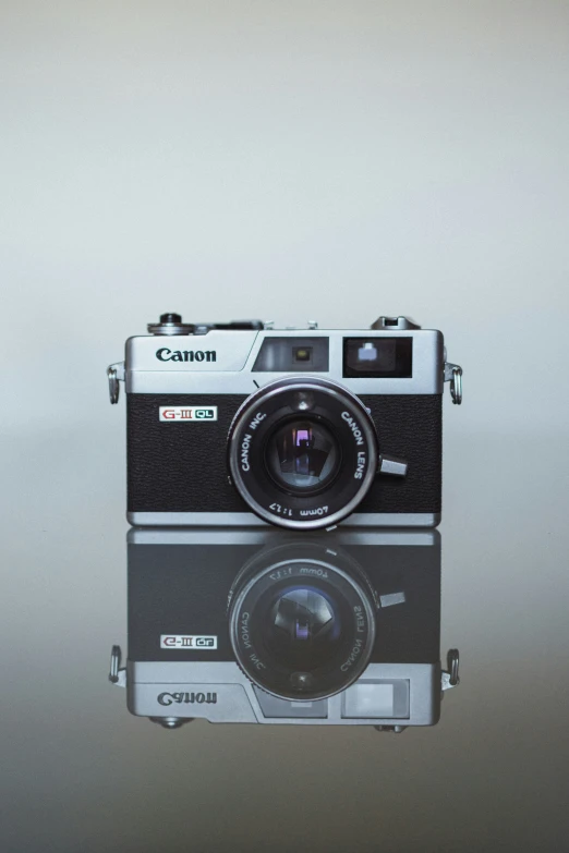 an old camera on top of a glass table