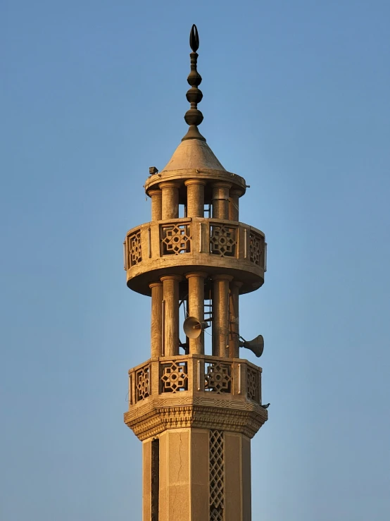 this tall tower contains an elaborate design that stands high above the city