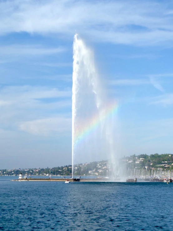 a large spout of water is near a city