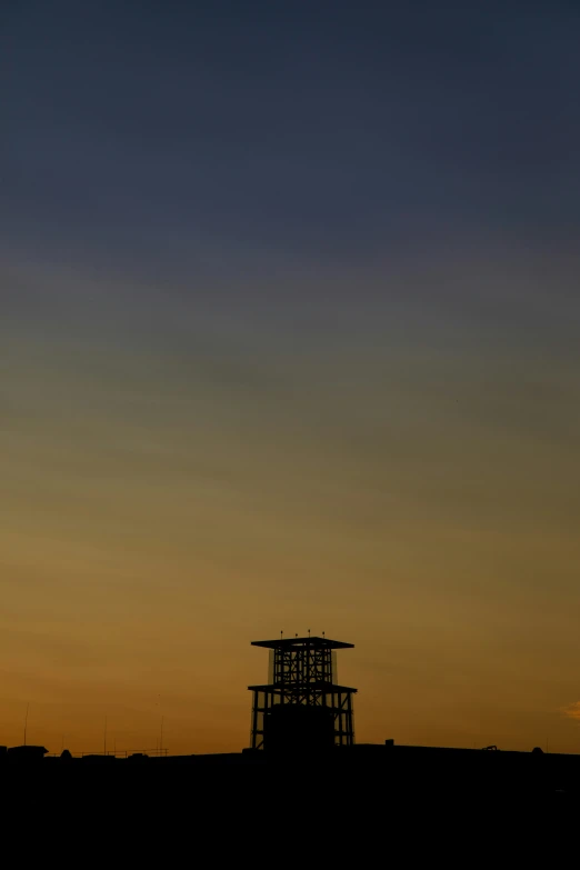 a clock tower is seen behind a building