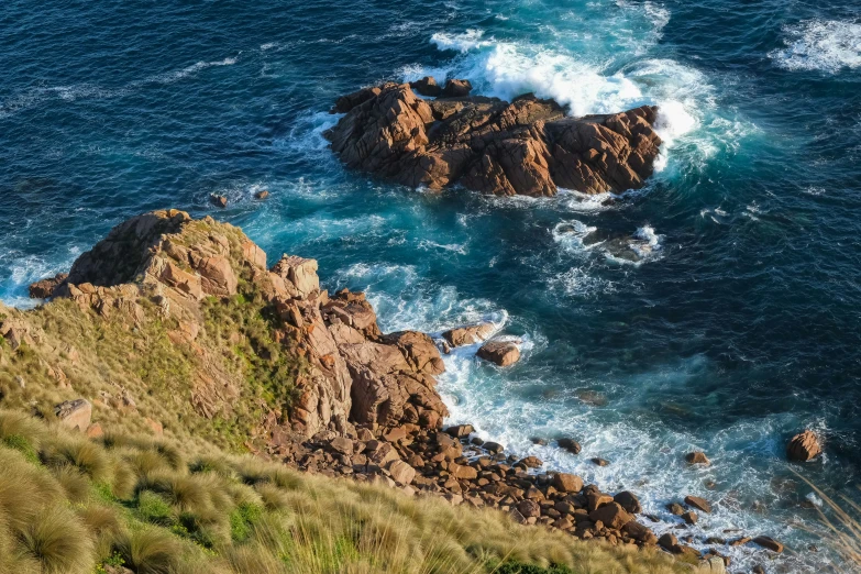 an aerial view of the ocean from a cliff