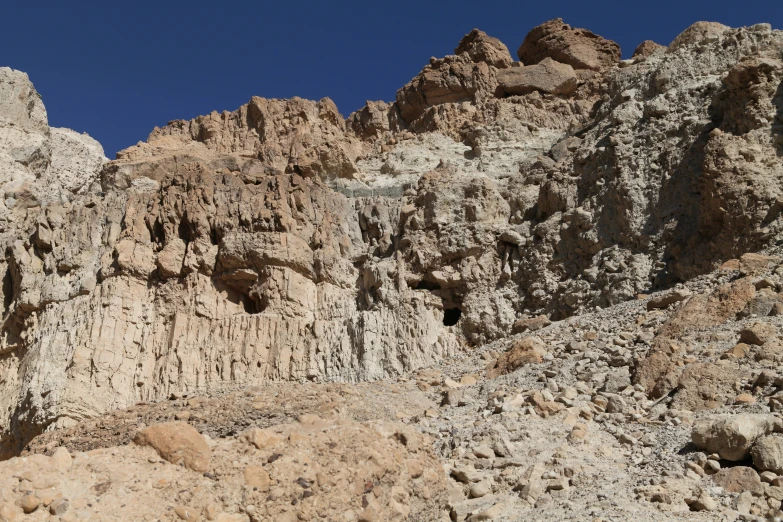 a mountain landscape with rocky peaks and a bird on the rock