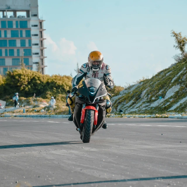 a man on a motorcycle is going down the street