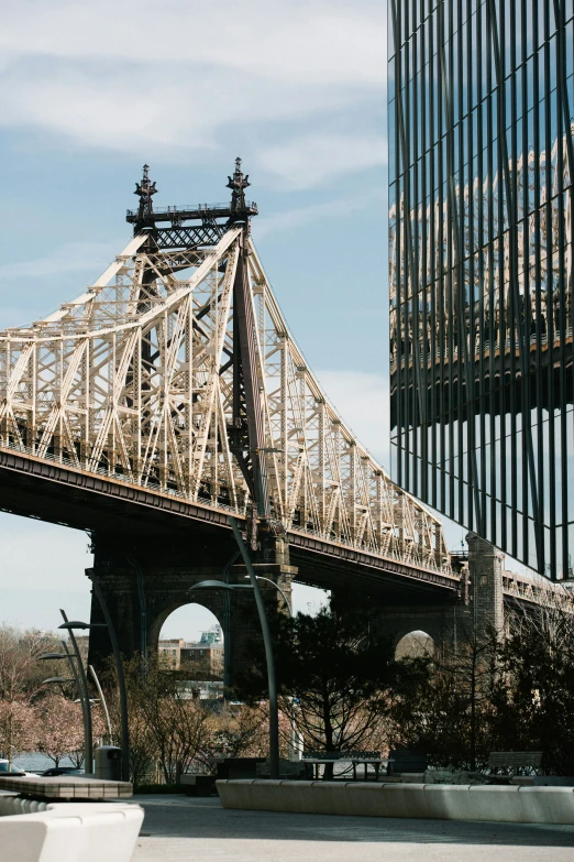 a very tall bridge over a river next to a building