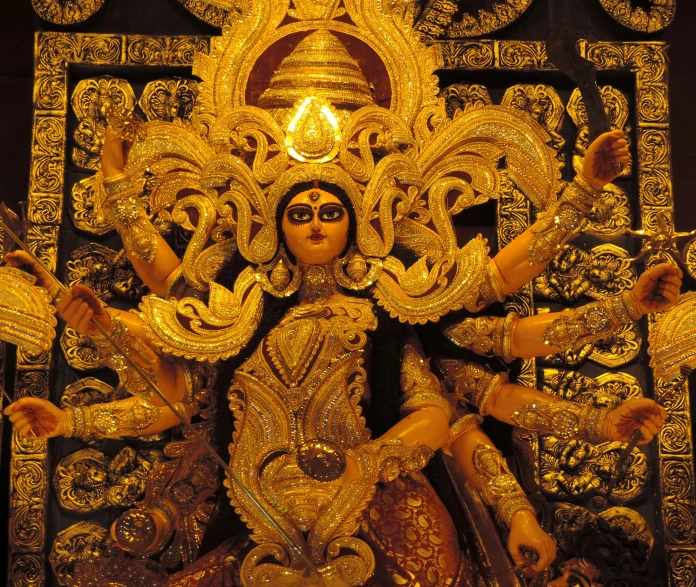 golden statue with elaborate gold decorations at night