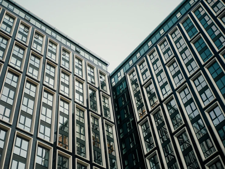 two tall buildings with clocks on them next to each other