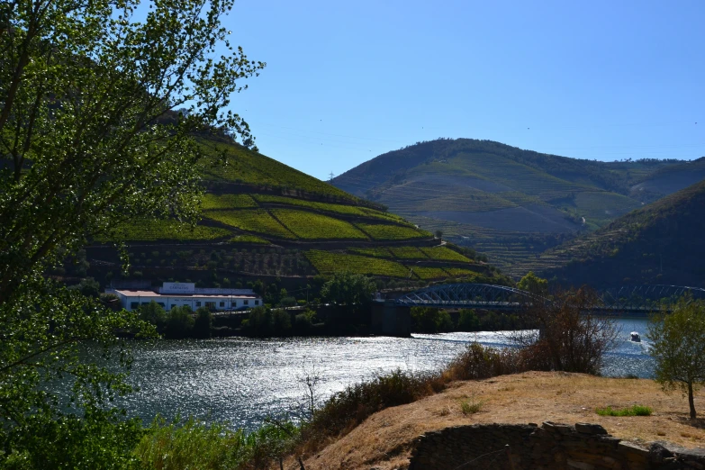 a body of water with hills in the distance