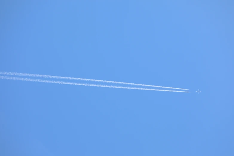 an airplane is flying in the clear blue sky