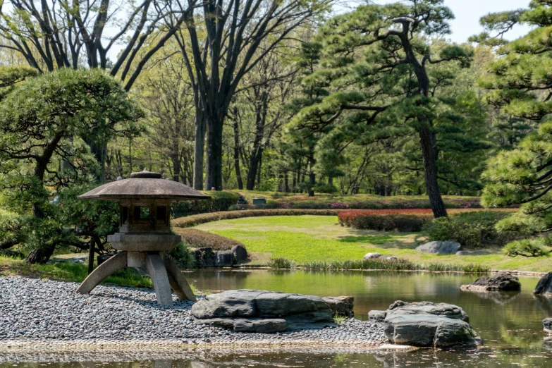 a gazebo in the middle of some rocks in front of a lake