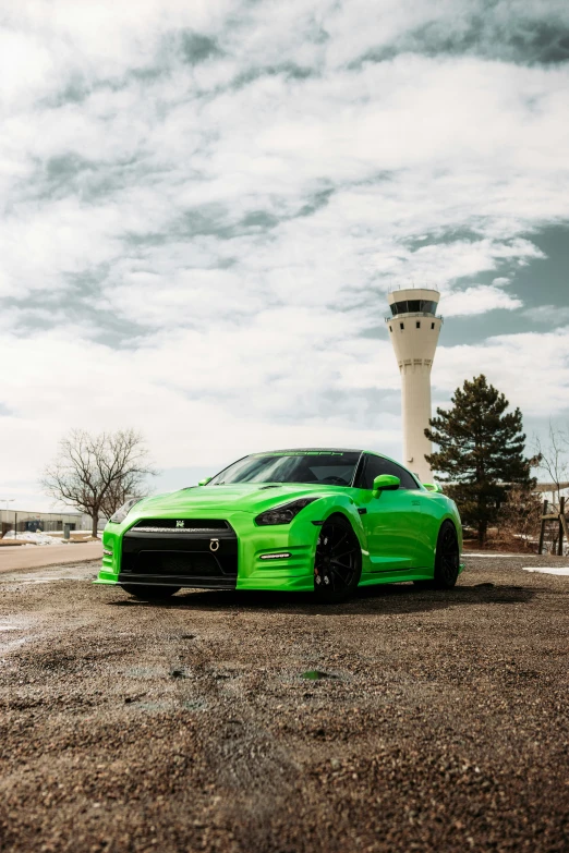 a car parked in front of an airport tower