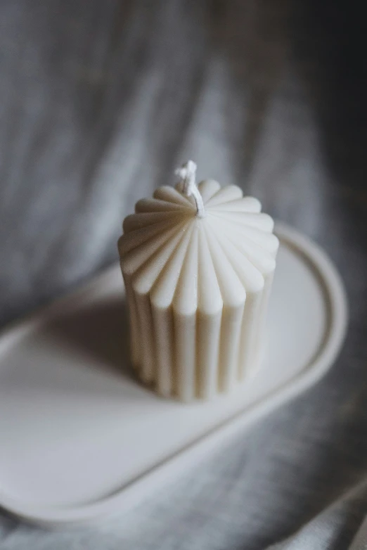 a muffin topped with white frosting sitting on a plate