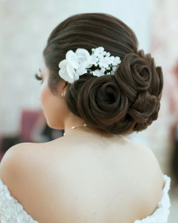 a woman with dark hair wears a wedding bouquet