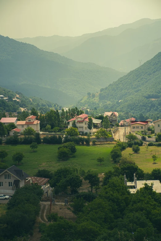 houses and farm homes nestled in the green mountains