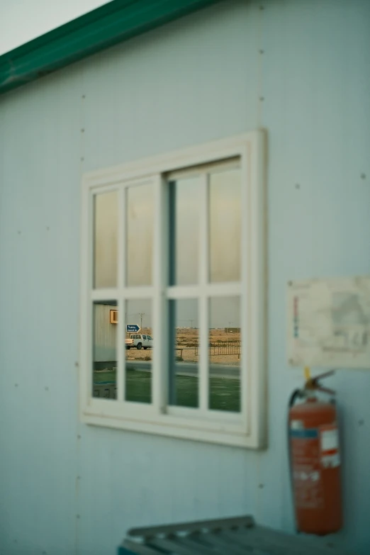 the back wall of a building reflecting into an open window