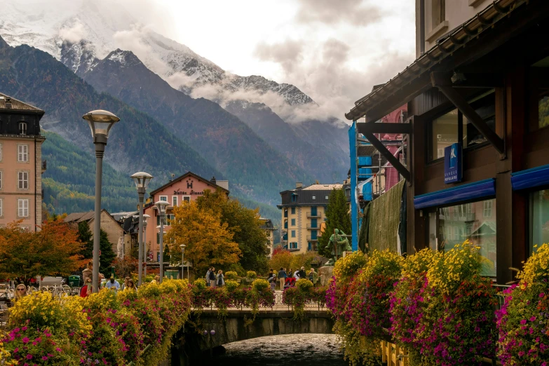 a street with buildings and a mountain range in the background