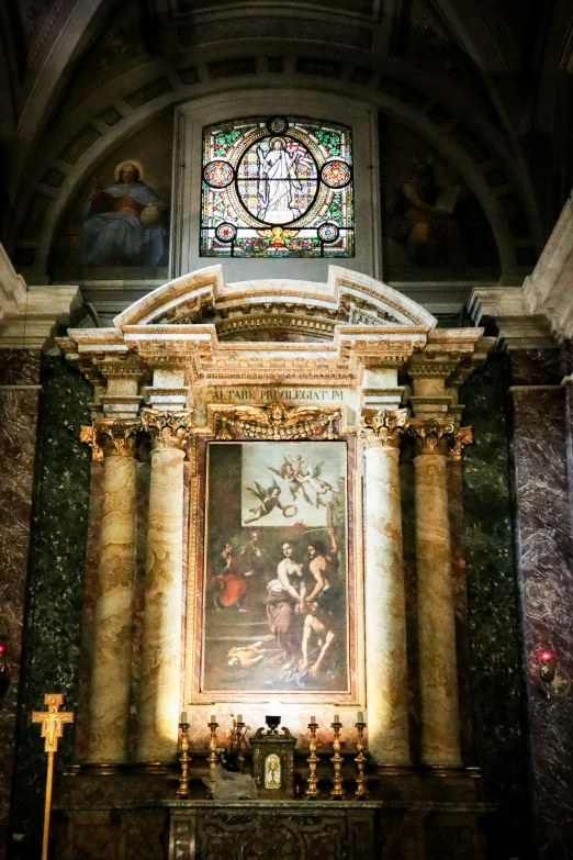 large and ornate painting displayed with a cross on either side of it