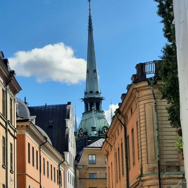 there is a tall building with a spire near other buildings