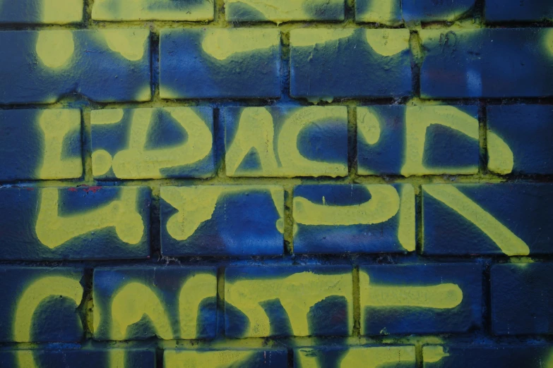 some graffiti writing on the side of a brick wall
