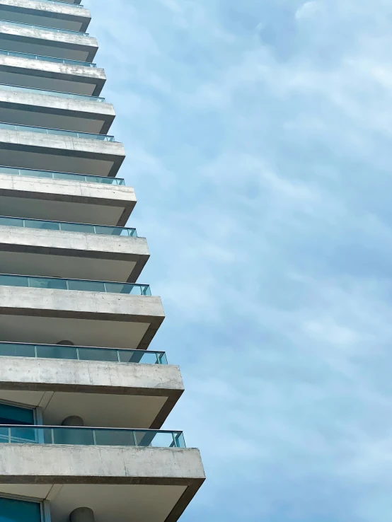 the tall building has balconies on the sides of it