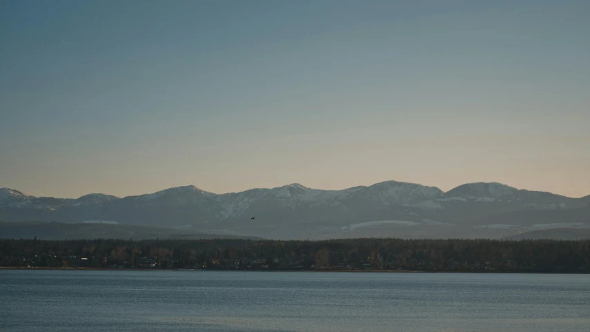 mountain range in distance at the edge of lake