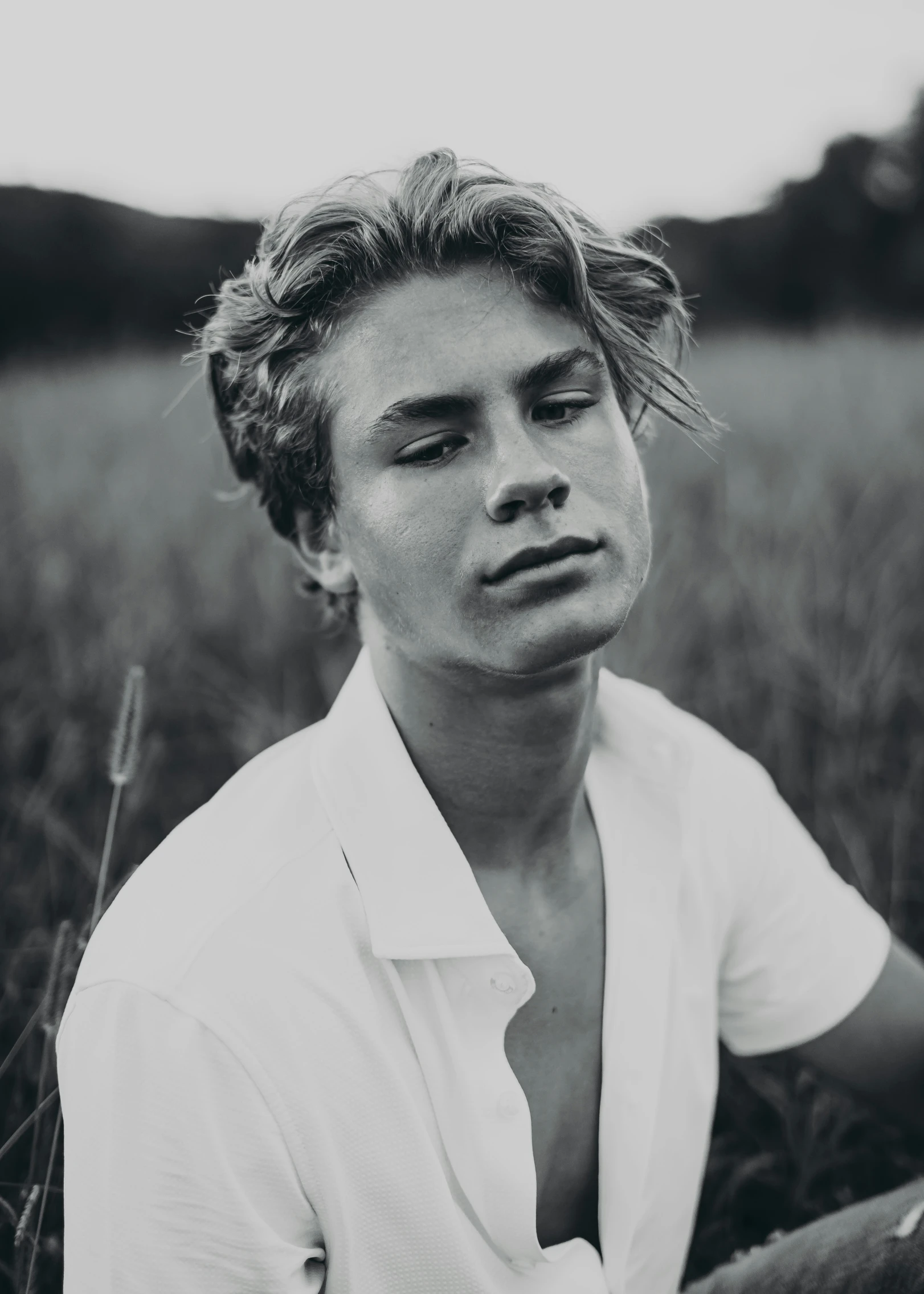 black and white image of man in field looking away