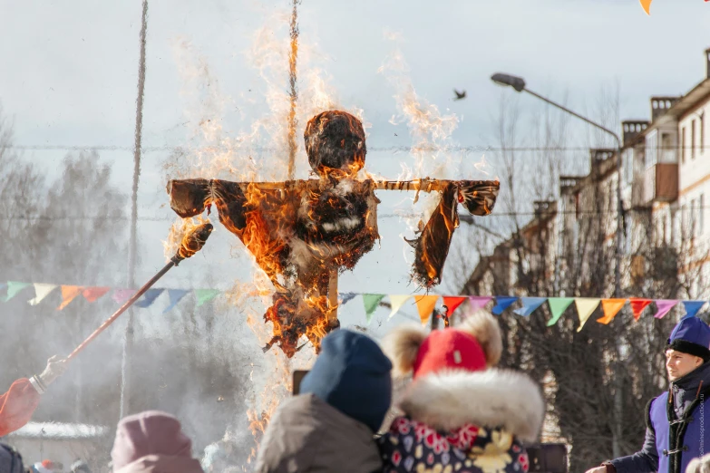 a large fire being lit on top of a statue