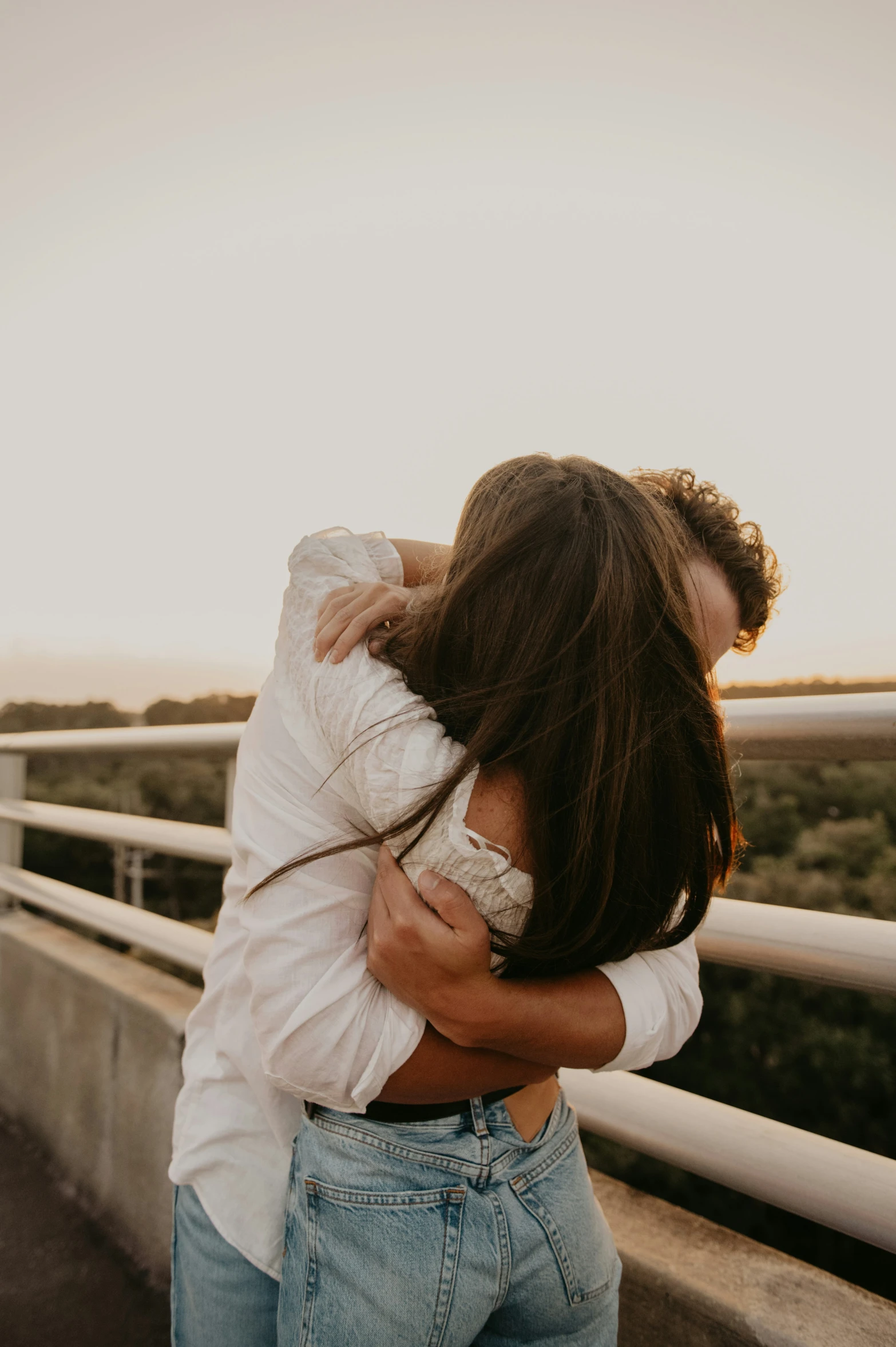 two people emcing each other on a bridge