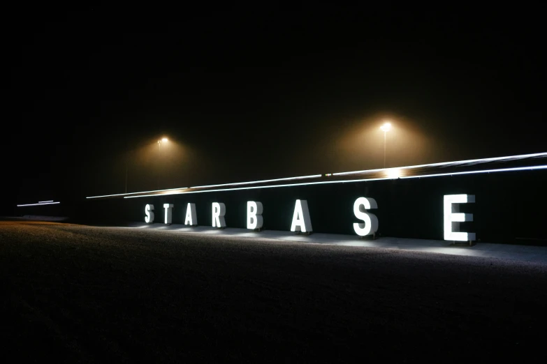 the words starbase light up at night in the dark