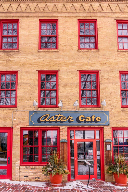 a brick building with red doors and windows