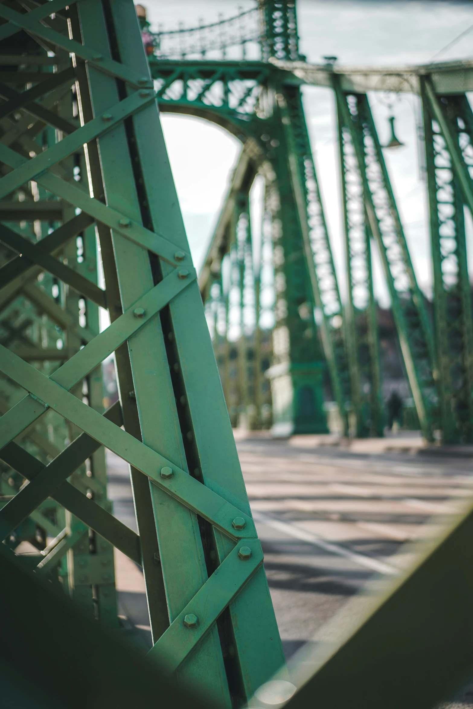 the underside of a bridge with multiple metal frameworks