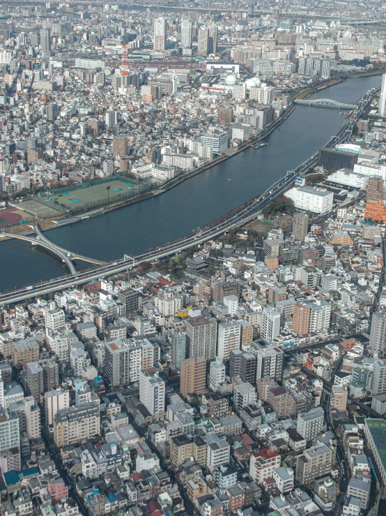 aerial view of river, highway and large city buildings