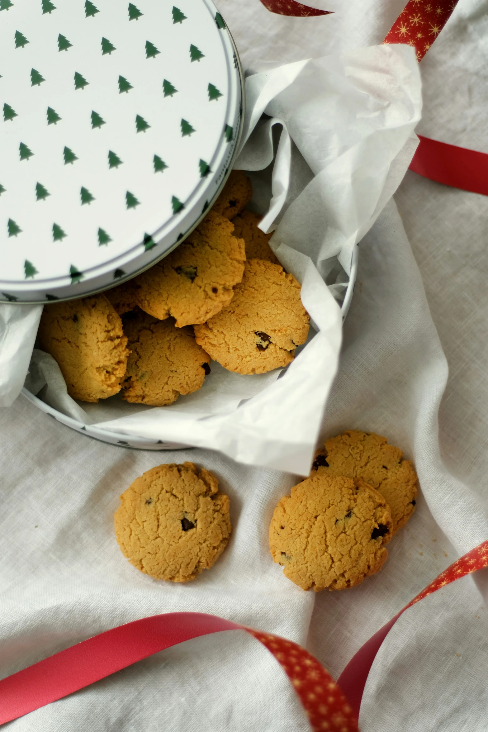 cookies in a bag on a table next to a ribbon