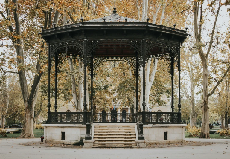 an ornate gazebo surrounded by trees and other foliage