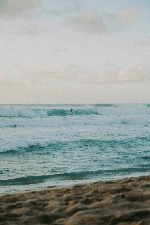 a couple of people riding surfboards on top of a wave