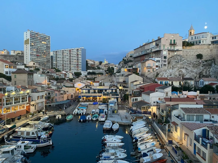 several boats are parked at a pier in the middle of a city