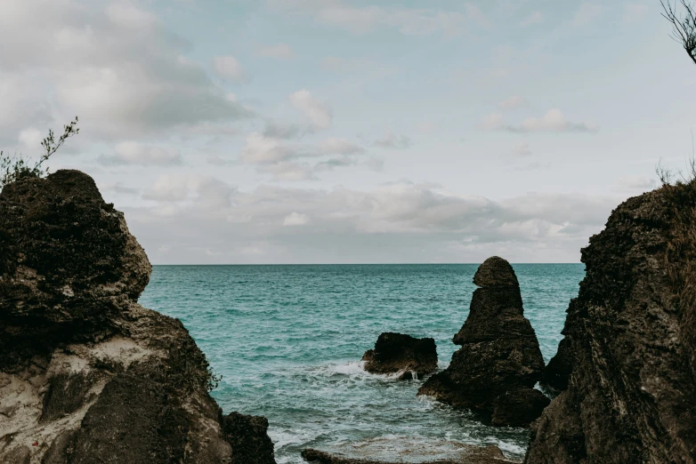 a couple of large rocks by the ocean