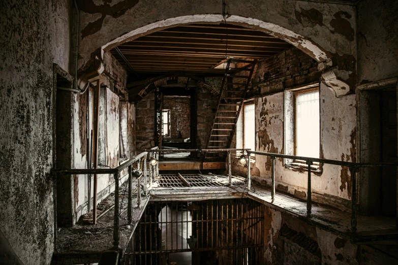 a barred iron fence in a run down building