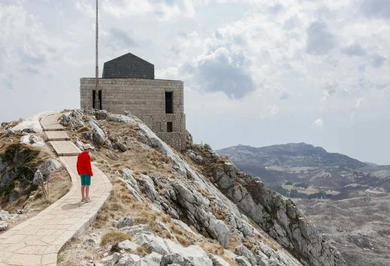 a person is standing at the top of a mountain