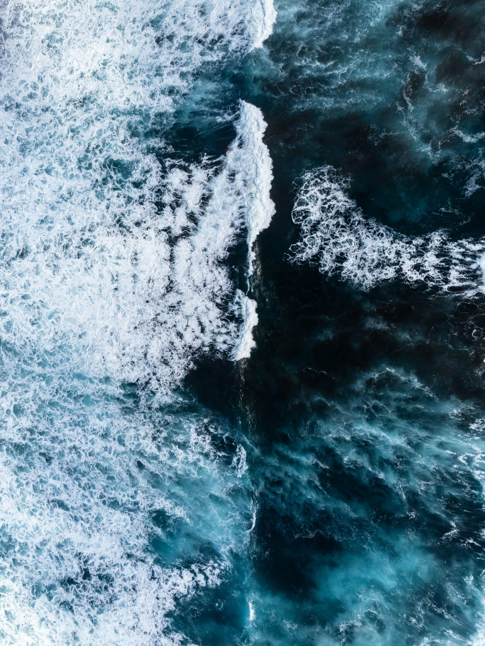 a view from above of the ocean and some blue water