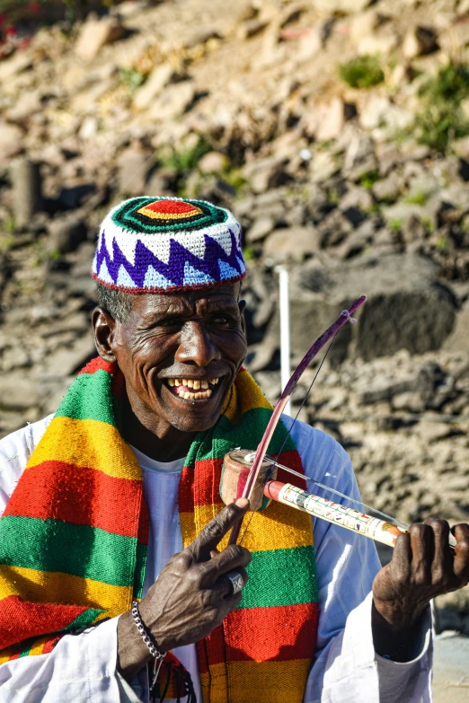 an african man holding a pair of tongs