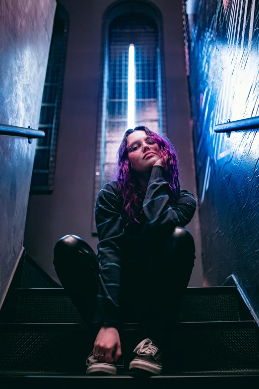 woman with red hair sitting on stairs looking up