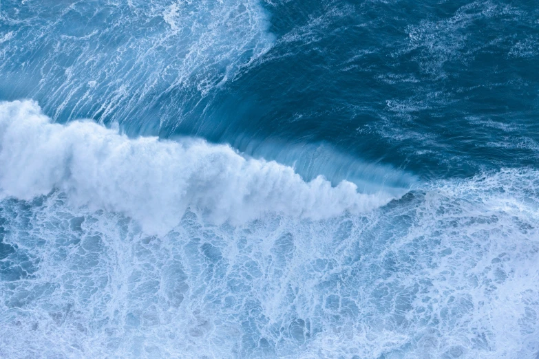 an ocean wave with rough waves crashing on it