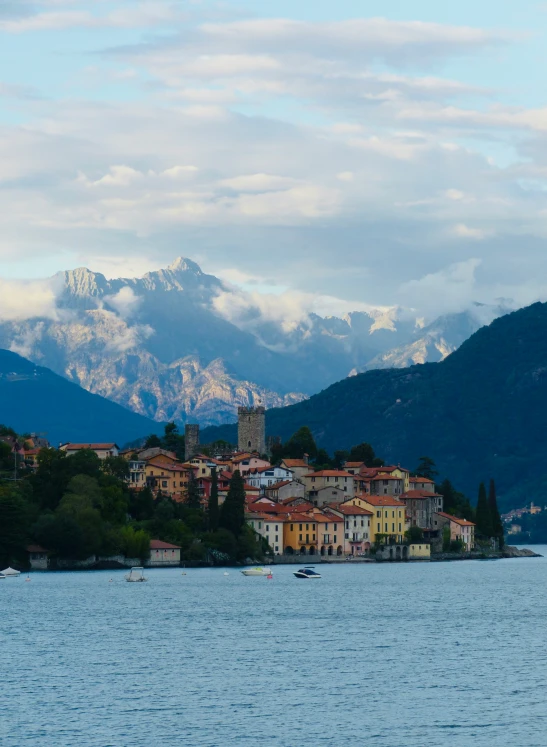 small boat on large body of water with mountains in background